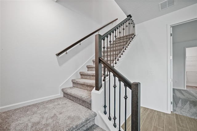 1180 Dora Parc Ln, Mount Dora, FL 32757 - staircase with baseboards, wood finished floors, and carpet floors