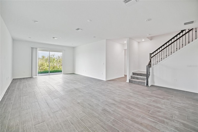 1180 Dora Parc Ln, Mount Dora, FL 32757 - unfurnished living room featuring wood finished floors, stairs, baseboards, and recessed lighting