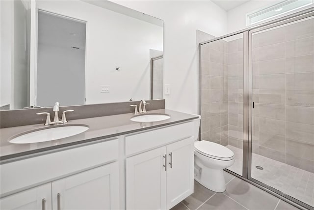 bathroom with vanity, tile patterned floors, toilet, and an enclosed shower