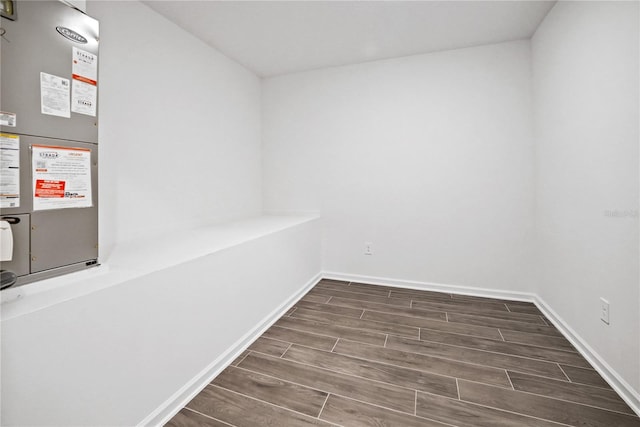 interior space featuring heating unit and dark hardwood / wood-style flooring