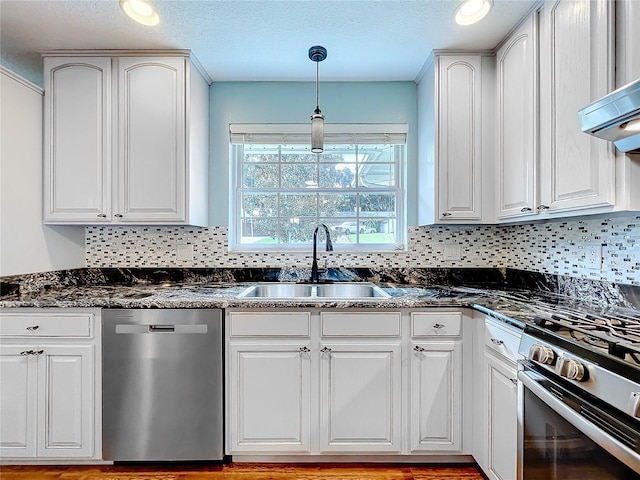 kitchen featuring white cabinetry, appliances with stainless steel finishes, sink, and pendant lighting