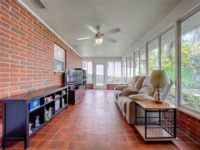 sunroom / solarium with plenty of natural light and ceiling fan