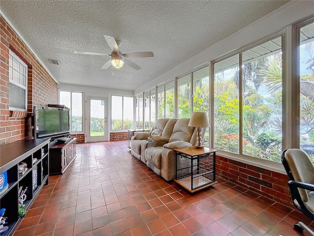 sunroom / solarium with ceiling fan and plenty of natural light