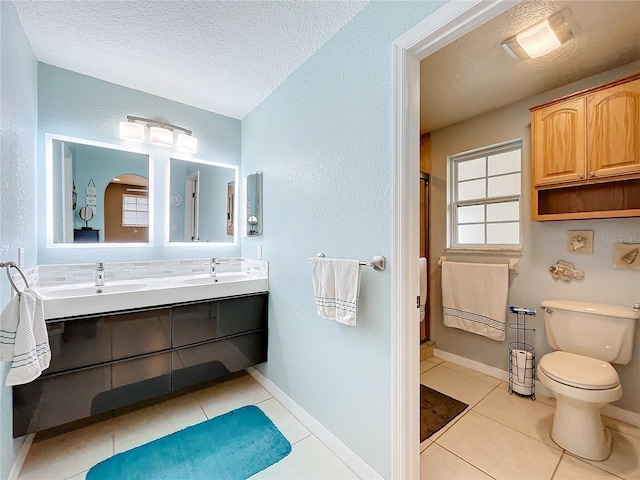 bathroom with a textured ceiling, toilet, vanity, an enclosed shower, and tile patterned flooring