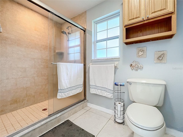 bathroom featuring toilet, tile patterned flooring, and an enclosed shower