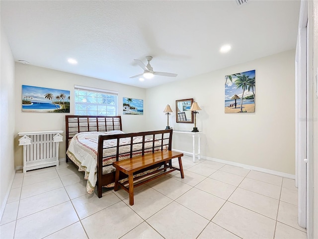 bedroom featuring a textured ceiling, light tile patterned floors, and ceiling fan