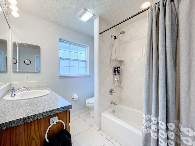 full bathroom featuring a textured ceiling, shower / bath combo, toilet, vanity, and tile patterned flooring