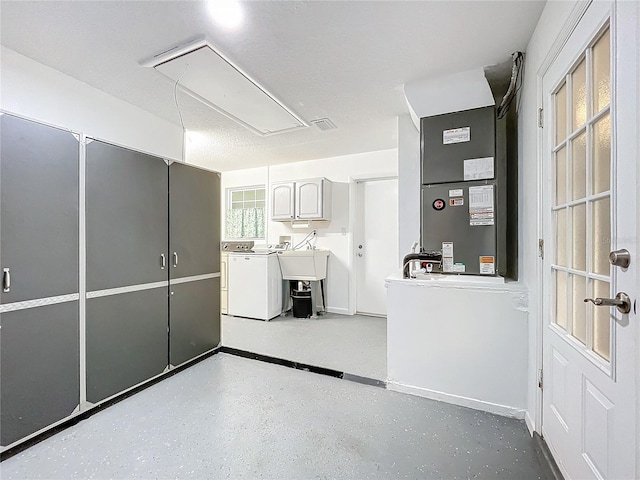 interior space featuring white cabinets, heating unit, and separate washer and dryer