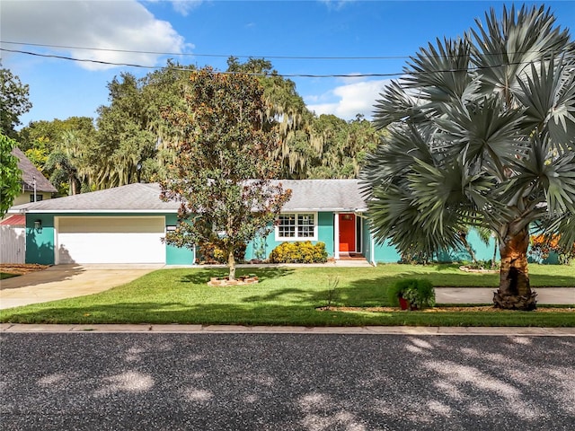 view of front of home featuring a garage and a front lawn