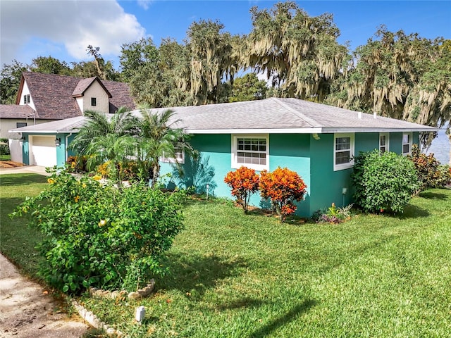 view of front of home with a front lawn and a garage