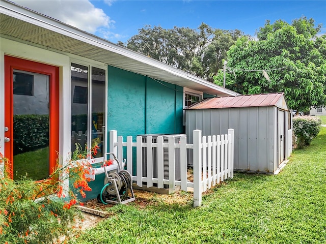 view of side of home with a storage shed and a lawn