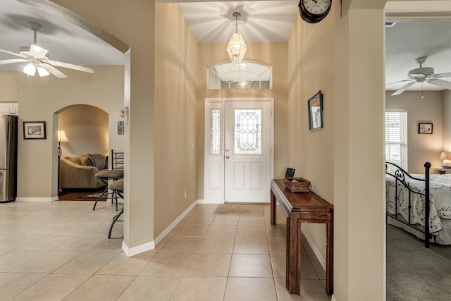 tiled foyer featuring a textured ceiling and ceiling fan