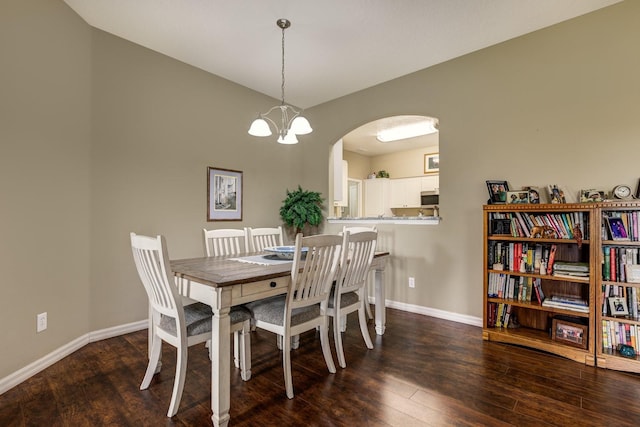 dining space with a chandelier and dark wood-type flooring