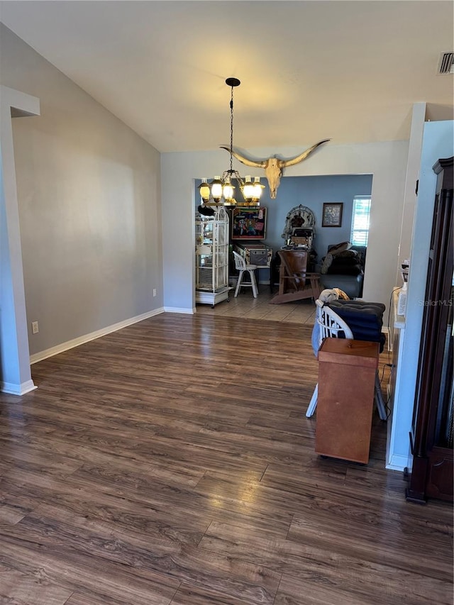 dining room featuring a notable chandelier and dark hardwood / wood-style floors