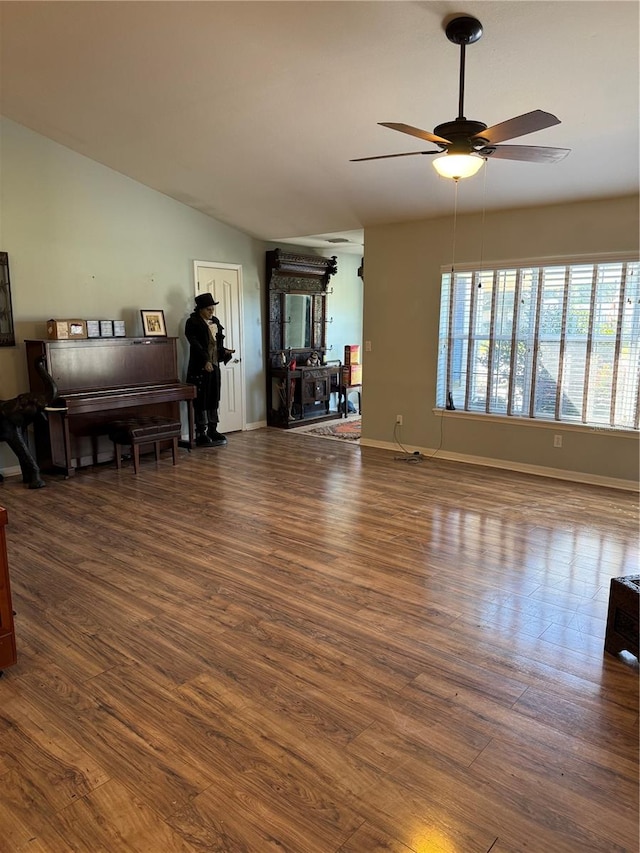 living room featuring ceiling fan and dark hardwood / wood-style flooring