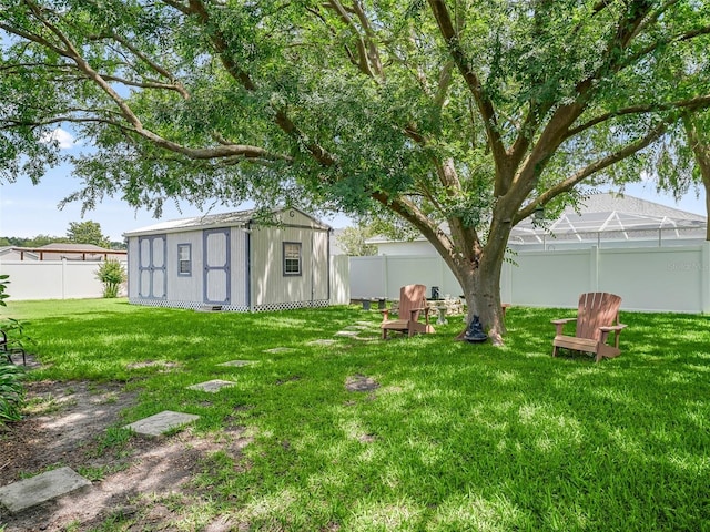 view of yard featuring a storage shed and glass enclosure