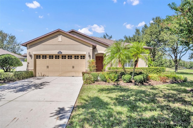 view of front of property featuring a front lawn and a garage