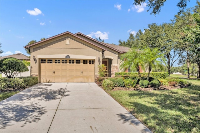 view of front of home with a front yard and a garage