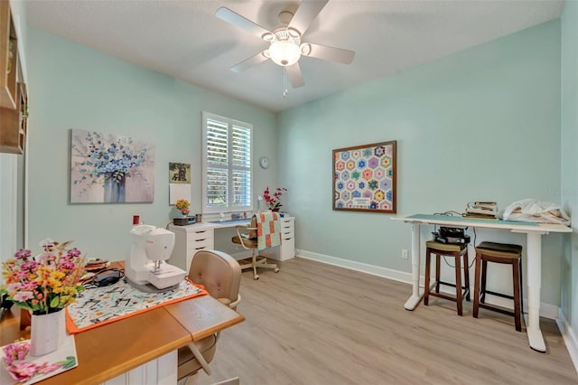 office area with light hardwood / wood-style floors and ceiling fan