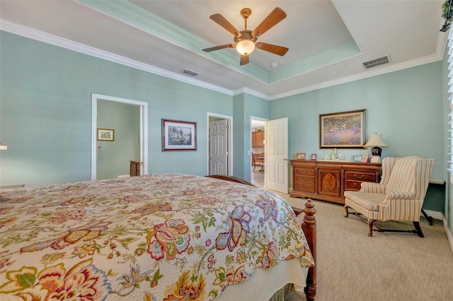 carpeted bedroom with ornamental molding, a raised ceiling, and ceiling fan