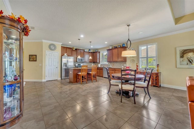 dining area featuring a healthy amount of sunlight, tile patterned floors, and ornamental molding