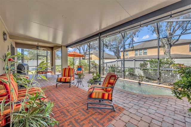 sunroom / solarium featuring ceiling fan