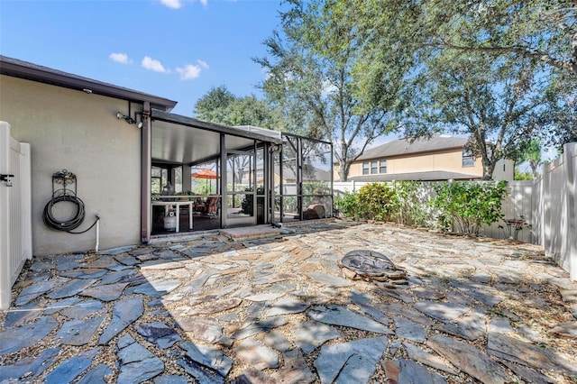 view of patio with a sunroom