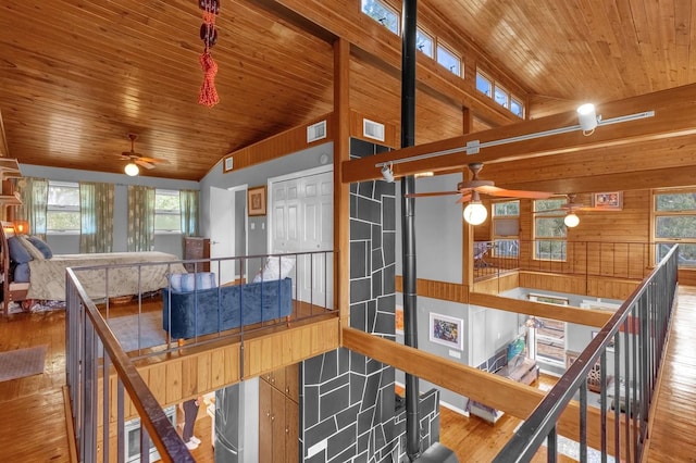 interior space with wood walls, hardwood / wood-style flooring, and wood ceiling