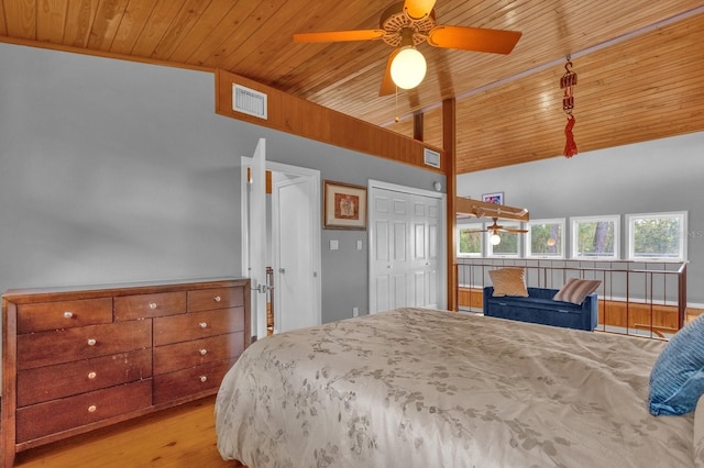 bedroom featuring light hardwood / wood-style floors, wood ceiling, and lofted ceiling