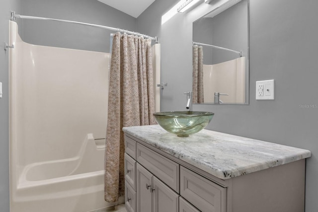 bathroom featuring vanity, shower / bath combo, and lofted ceiling