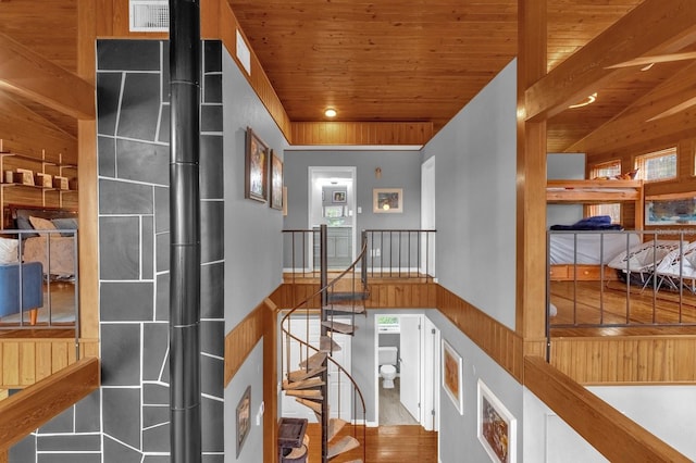 hall featuring wood ceiling, wood-type flooring, and lofted ceiling