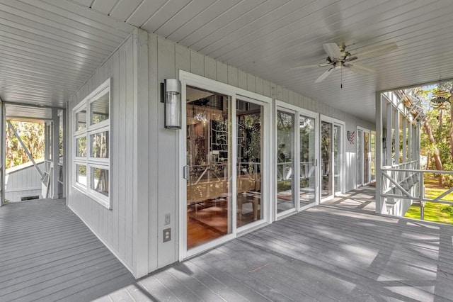 unfurnished sunroom featuring wooden ceiling and ceiling fan