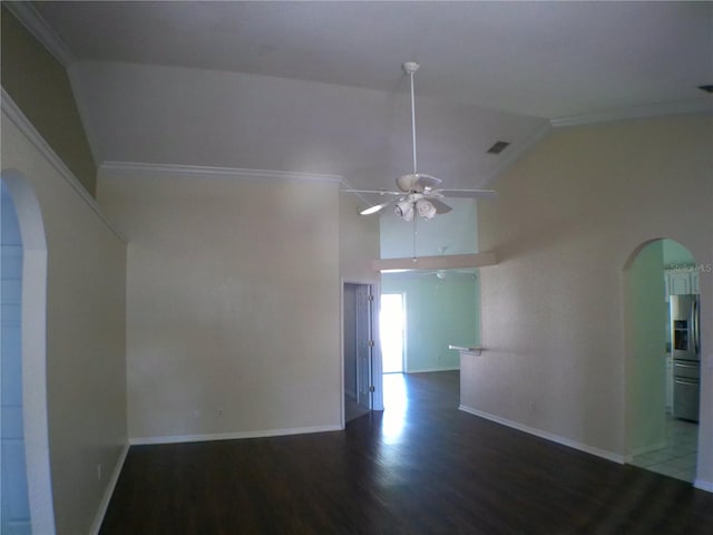 spare room with lofted ceiling, ceiling fan, crown molding, and dark hardwood / wood-style flooring