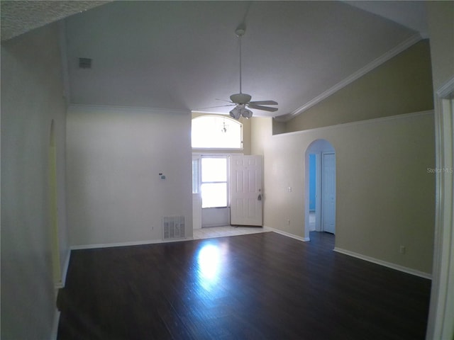 foyer with ceiling fan, lofted ceiling, ornamental molding, and dark hardwood / wood-style flooring