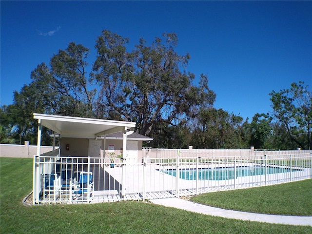 view of swimming pool with a patio and a lawn