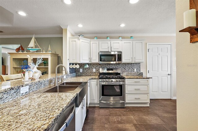 kitchen featuring white cabinets, stainless steel appliances, and backsplash