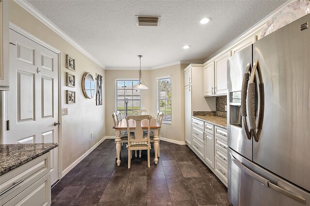 kitchen featuring white cabinets, dark stone countertops, crown molding, stainless steel refrigerator with ice dispenser, and decorative light fixtures