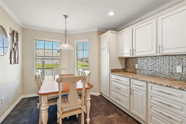 dining area featuring crown molding and a textured ceiling