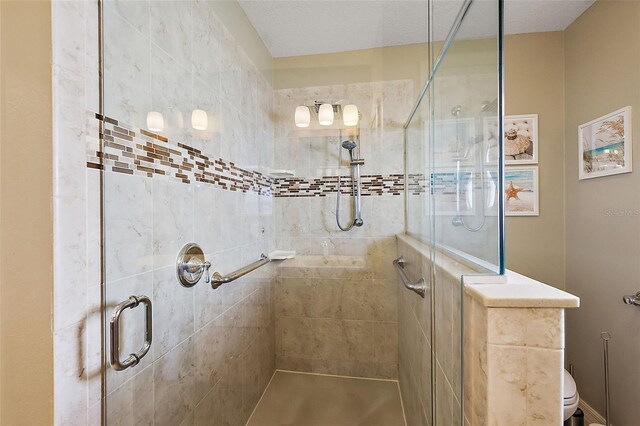 bathroom featuring toilet and an enclosed shower