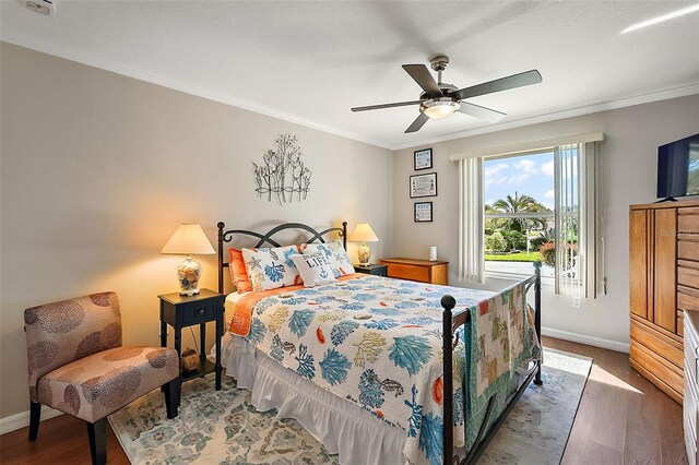 bedroom featuring crown molding, wood-type flooring, and ceiling fan