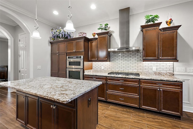 kitchen featuring wall chimney exhaust hood, pendant lighting, dark hardwood / wood-style floors, and stainless steel appliances