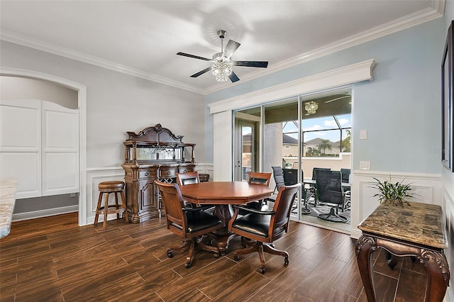 dining area featuring dark wood-type flooring, ceiling fan, and ornamental molding