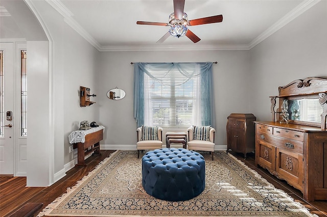 living area featuring crown molding, ceiling fan, and dark hardwood / wood-style flooring