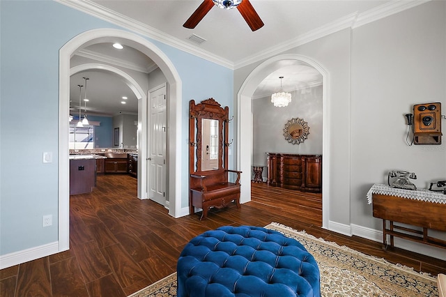 corridor featuring ornamental molding, dark hardwood / wood-style floors, a chandelier, and a wealth of natural light