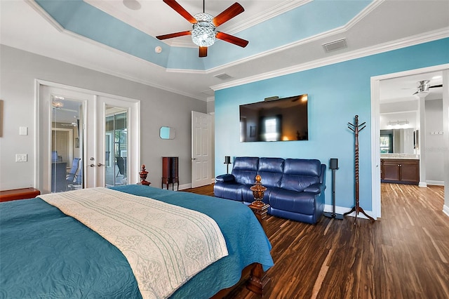 bedroom with ensuite bathroom, a tray ceiling, ceiling fan, crown molding, and dark hardwood / wood-style floors