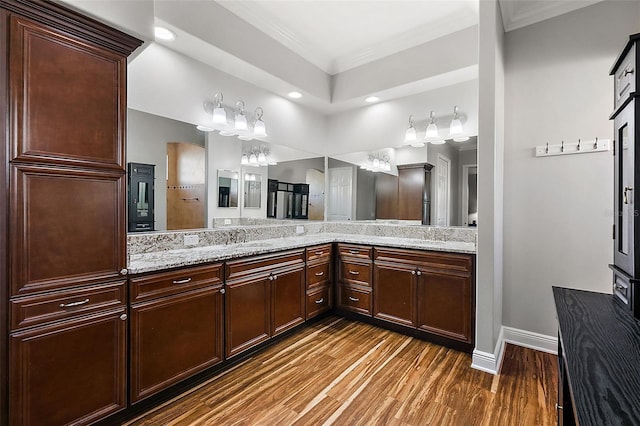 bathroom with vanity, ornamental molding, and hardwood / wood-style flooring