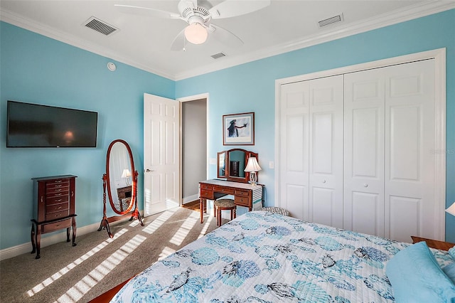 bedroom featuring a closet, ceiling fan, light carpet, and ornamental molding