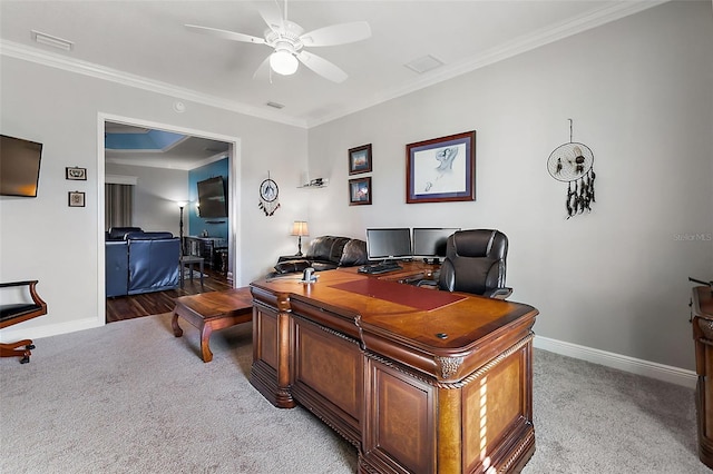 carpeted office space with ornamental molding and ceiling fan