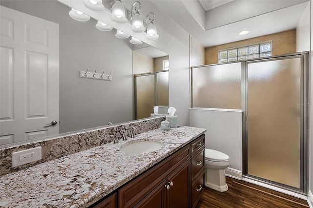 bathroom featuring vanity, toilet, hardwood / wood-style flooring, and an enclosed shower