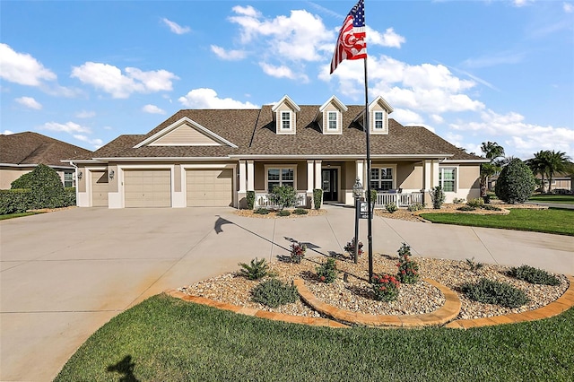 view of front of home featuring a front yard, a porch, and a garage